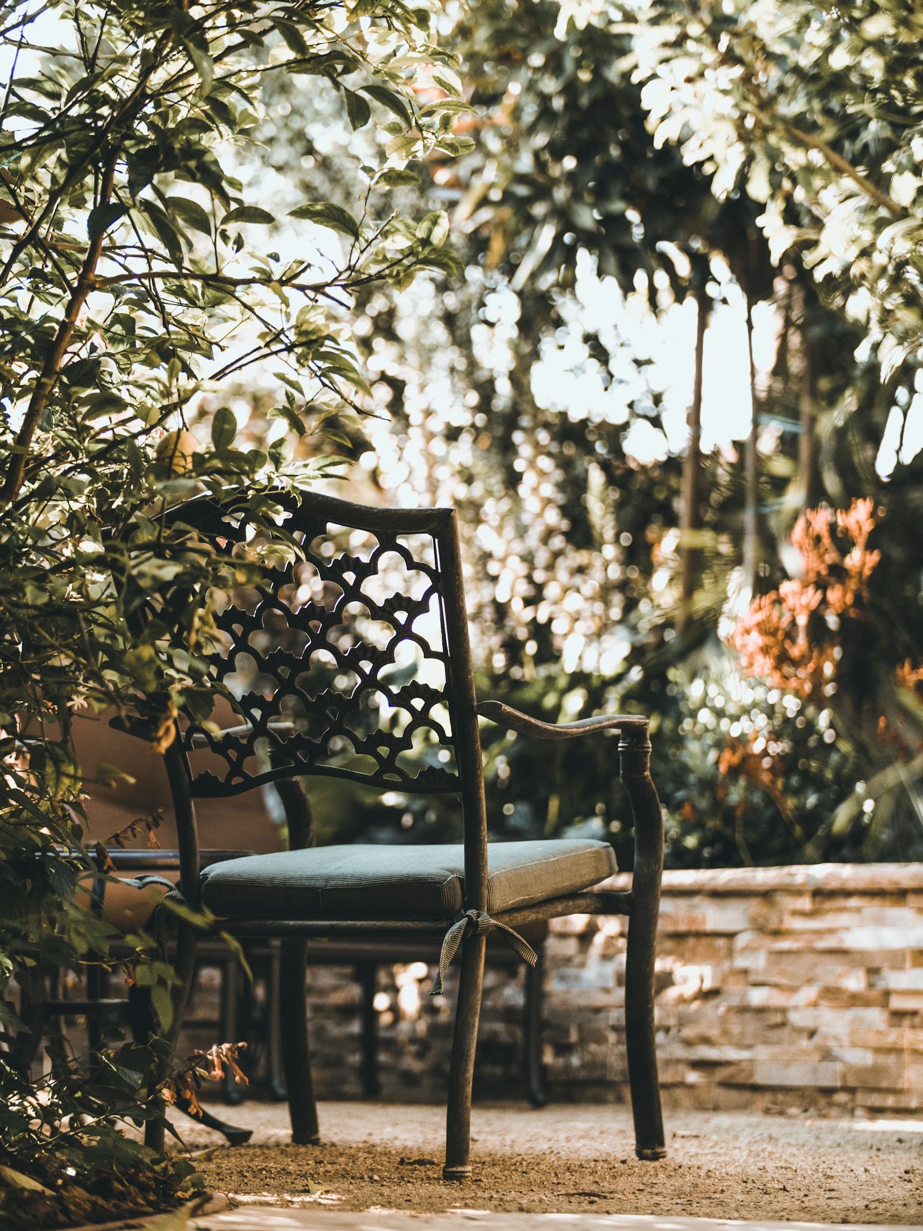 A pergola-shaded patio with seating set into a manicured yard